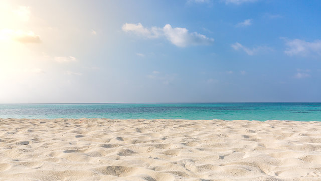 Empty tropical beach background. Horizon with sky and white sand