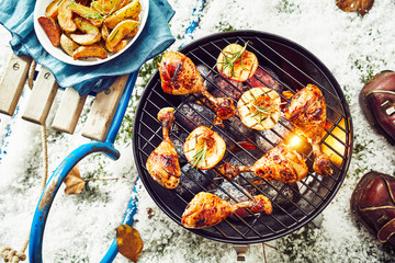 Tasty spicy marinated chicken legs on a barbecue