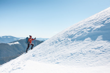 Fototapeta na wymiar A man climbs to the top of the mountain.