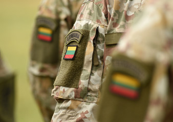 Lithuania patch flag on soldiers arm. Lithuanian military uniform. Lithuania troops