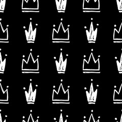 Vector seamless pattern with abstract hand drawn silhouettes of crowns