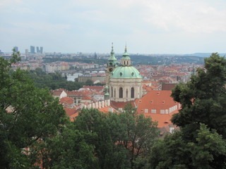 Obraz premium Panorama of Prague, view of the city roofs and domes of churches