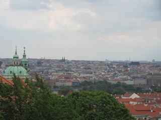 Fototapeta na wymiar Panorama of Prague, view of the city roofs and domes of churches