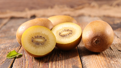 yellow kiwi on wood background