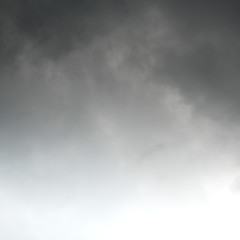 Squared image of moody dark clouds, white copy space at the bottom. Gradient from top to bottom.