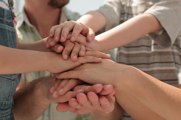 hands of the family are stacked together