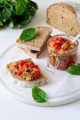 Rye bread toasts and glass jar with eggplant caviar. Vegetable appetizer or antipasti. Healthy food concept