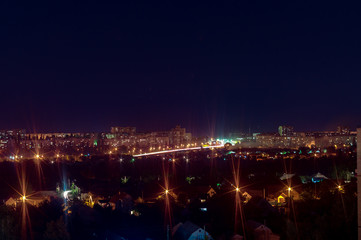 Fototapeta na wymiar Long exposure night photo. A lot of lights symbolized Big city life at night. Night city illumination. Night cityscape.