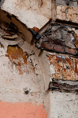 Texture of old plaster wall with red and pink bricks background. Old house in the centre of the European city.