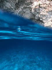 Underwater photo from amazing tropical paradise exotic caves in Blue Lagoon with deep blue ocean clear waters