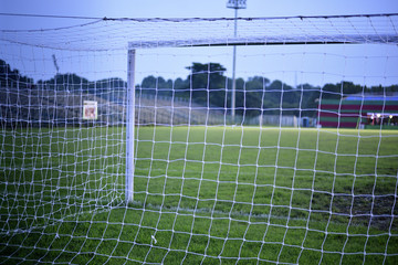 photograph is taken from behind the empty soccer goal