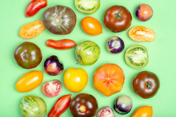 Flat lay top view food background with multicolored assortment of French fresh ripe tomatoes