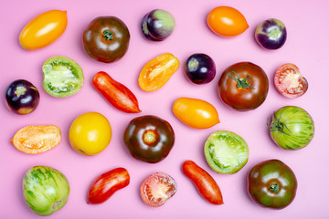 Flat lay top view food background with multicolored assortment of French fresh ripe tomatoes