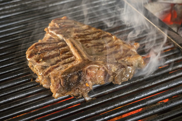 Beef steaks on the grill with flames