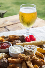 Fresh beer snacks assortment on wooden board