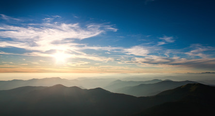 Silhouettes of mountains on background of dawn sky