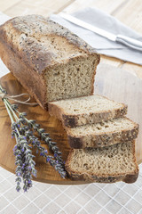 Assortment of baked bread on wooden table background