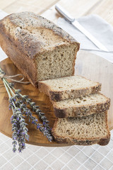 Assortment of baked bread on wooden table background