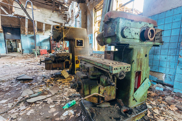 Fototapeta premium Old industrial machine tools in workshop. Rusty metal equipment in abandoned factory