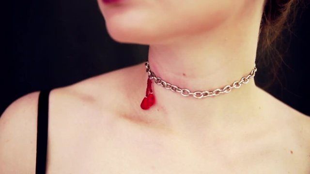 decoration on the neck in the form of a drop of blood