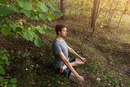 Yoga Meditation Concept, Man In Lotus Pose Meditating Outdoors In Forest Nature