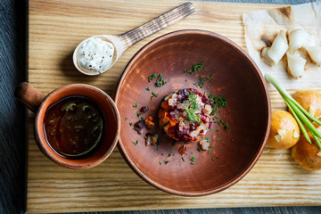 wooden table topped with plates of traditional ukrainian food