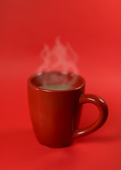 a red cup of coffee on the red background with space for product display montage.
