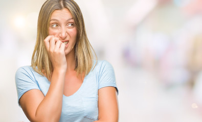 Obraz premium Young beautiful woman over isolated background looking stressed and nervous with hands on mouth biting nails. Anxiety problem.