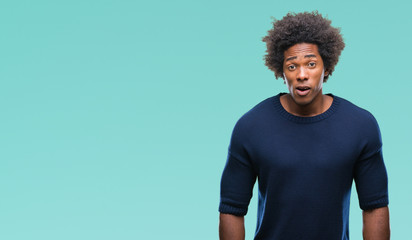 Afro american man over isolated background afraid and shocked with surprise expression, fear and excited face.