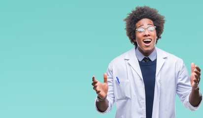 Afro american doctor scientist man over isolated background celebrating crazy and amazed for success with arms raised and open eyes screaming excited. Winner concept