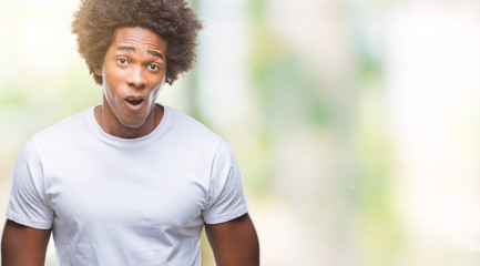 Afro american man over isolated background afraid and shocked with surprise expression, fear and...