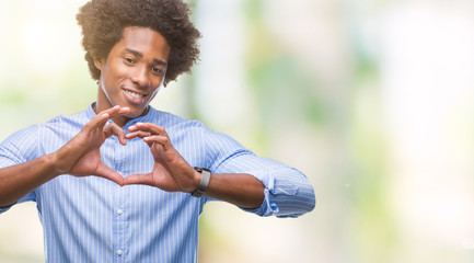 Afro american man over isolated background smiling in love showing heart symbol and shape with hands. Romantic concept.