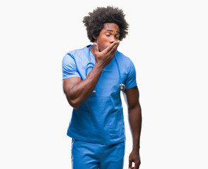 Fototapeta na wymiar Afro american surgeon doctor man over isolated background bored yawning tired covering mouth with hand. Restless and sleepiness.