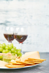 Cheese plate variety, and wine in glasses