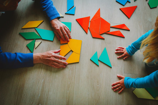 teacher and child playing with geometric shapes