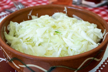 Delicious vegetarian appetizer from Serbian cuisine - fresh green coleslaw salad with herbs, pepper and olive oil dressing
