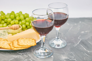 Cheese plate variety, and wine in glasses