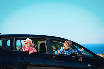 happy little boy and girl enjoy travel by car at sea