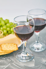 Cheese plate variety, and wine in glasses