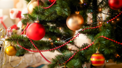 Closeup image of colorful baubles on decorated Christmas tree