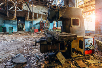 Old industrial machine tools in workshop. Rusty metal equipment in abandoned factory