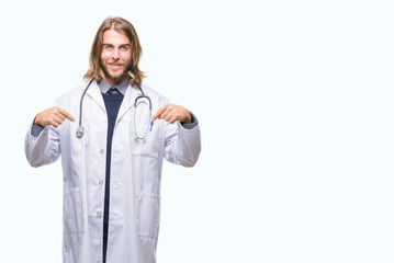 Young handsome doctor man with long hair over isolated background looking confident with smile on face, pointing oneself with fingers proud and happy.