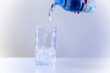 Glass of pure water on a white kitchen table