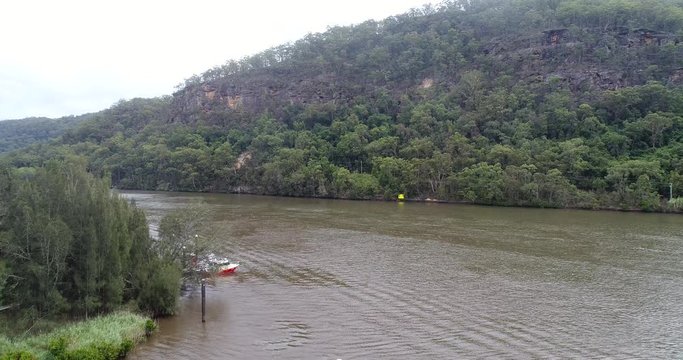 Vehicle ferry off-loading cars at the ramp of Wiseman ferry town on Hawkesbury river &ndash; landing down to the shore.
