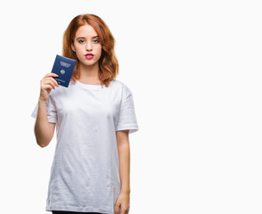 Fototapeta premium Young beautiful woman holding passport of germany over isolated background with a confident expression on smart face thinking serious