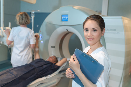 female patient undergoing ct scan test in examination room