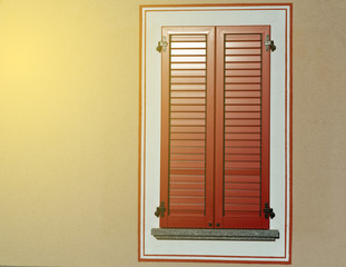 Window in Italy style with red window shutters.