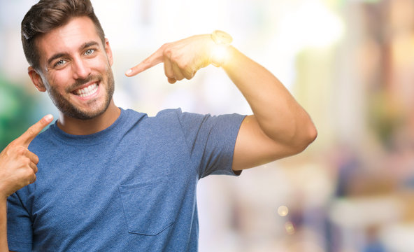 Young Handsome Man Over Isolated Background Smiling Confident Showing And Pointing With Fingers Teeth And Mouth. Health Concept.