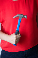 Woman holding the hammer in the hands