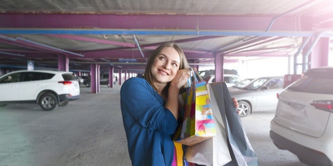 sale concept. woman with a shopping bags. Beautiful woman at the parking shopping center with bags.